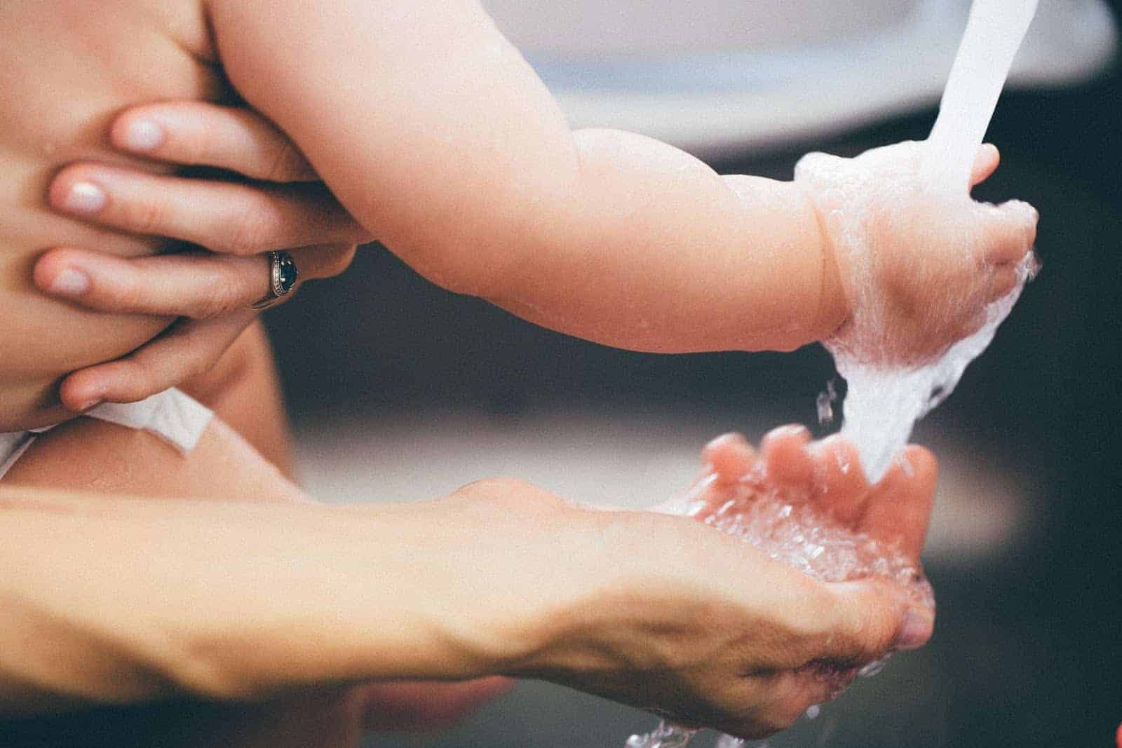 Baby and mom washing their hands.  