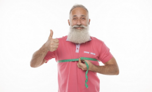 Older mad with a measuring tape around his chest to demonstrate fat loss over fifty
