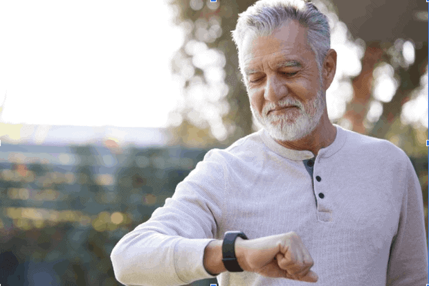 Older man looking at a watch to check heart rate variability