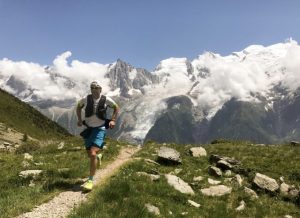 Athletic man running in the mountains to demonstrate how to accomplish your fitness goals