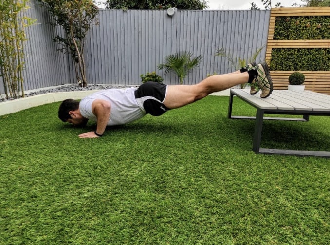 Man doing incline push ups in order to demonstrate how to accomplish your fitness goals