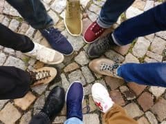 People wearing many different types of shoes.