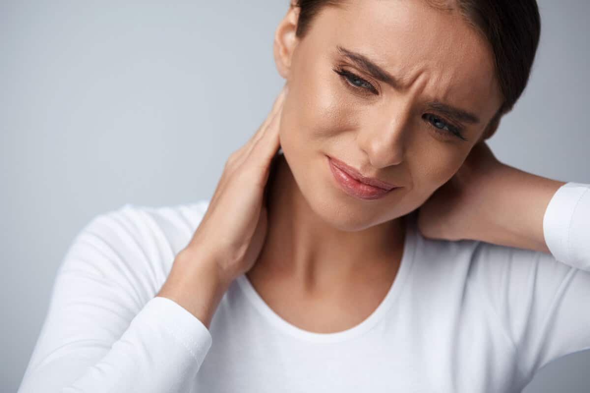 Young woman suffering from neck pain